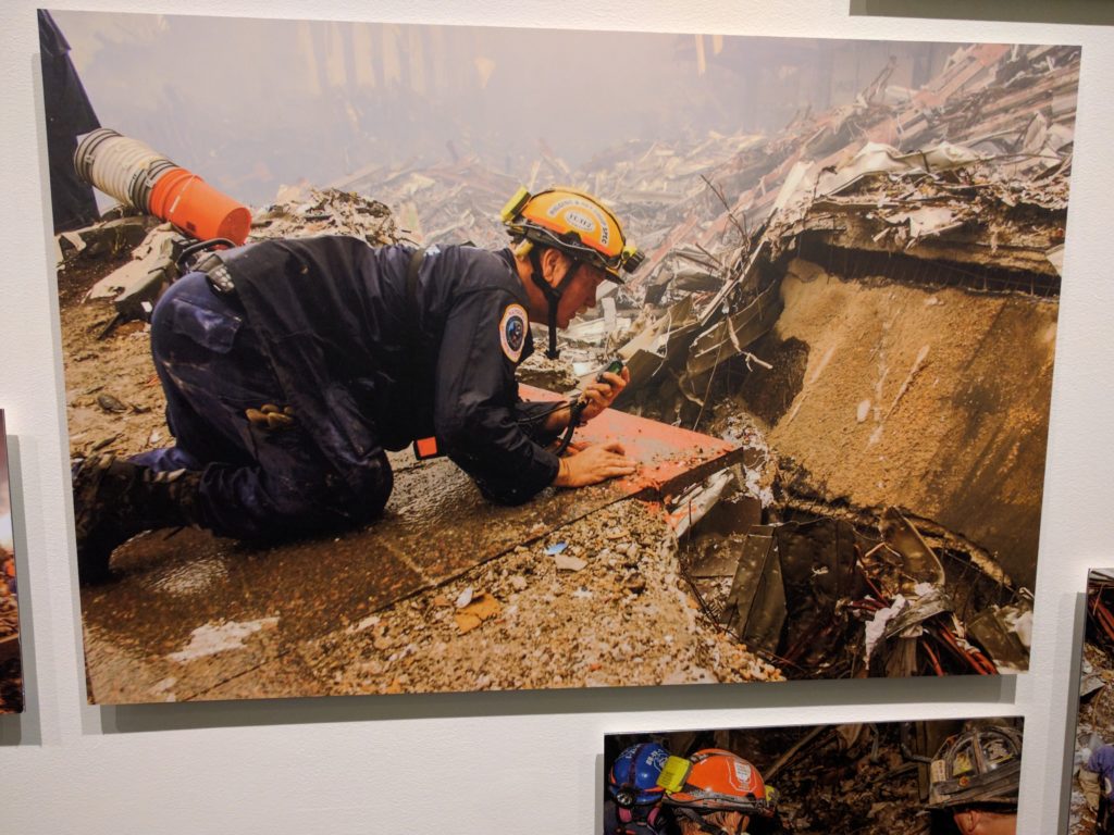 A rescue worker crawls through the rubble in the aftermath of 9/11. Photo by Andrea Booher.